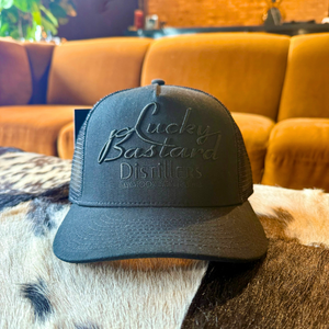 LUCKY BASTARD TRUCKER HAT- BLACK ON BLACK
