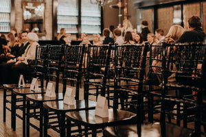 Lucky Bastard Distillers with wooden floors and high ceilings, set up for an event with chairs and tables. 1920 style prohibition era Bar and event room decorated for a wedding in Saskatoon Saskatchewan YXE Canada must see must do while visiting bridge city.