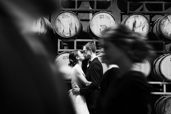Lucky Bastard Distillers with wooden floors and high ceilings, set up for an event with chairs and tables. 1920 style prohibition era Bar and event room decorated for a wedding in Saskatoon Saskatchewan YXE Canada must see must do while visiting bridge city.