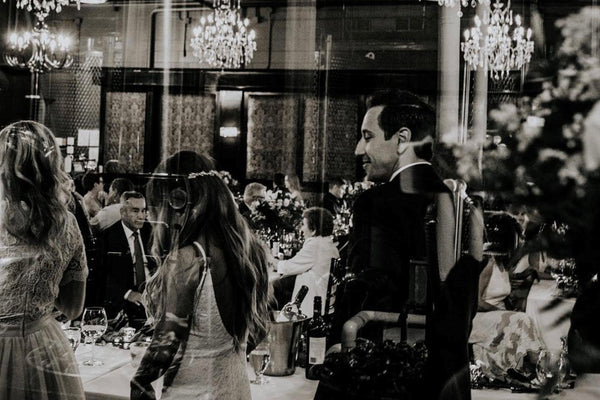 Lucky Bastard Distillers with wooden floors and high ceilings, set up for an event with chairs and tables. 1920 style prohibition era Bar and event room decorated for a wedding in Saskatoon Saskatchewan YXE Canada must see must do while visiting bridge city.